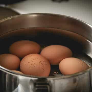 eggs covered with water in a pot