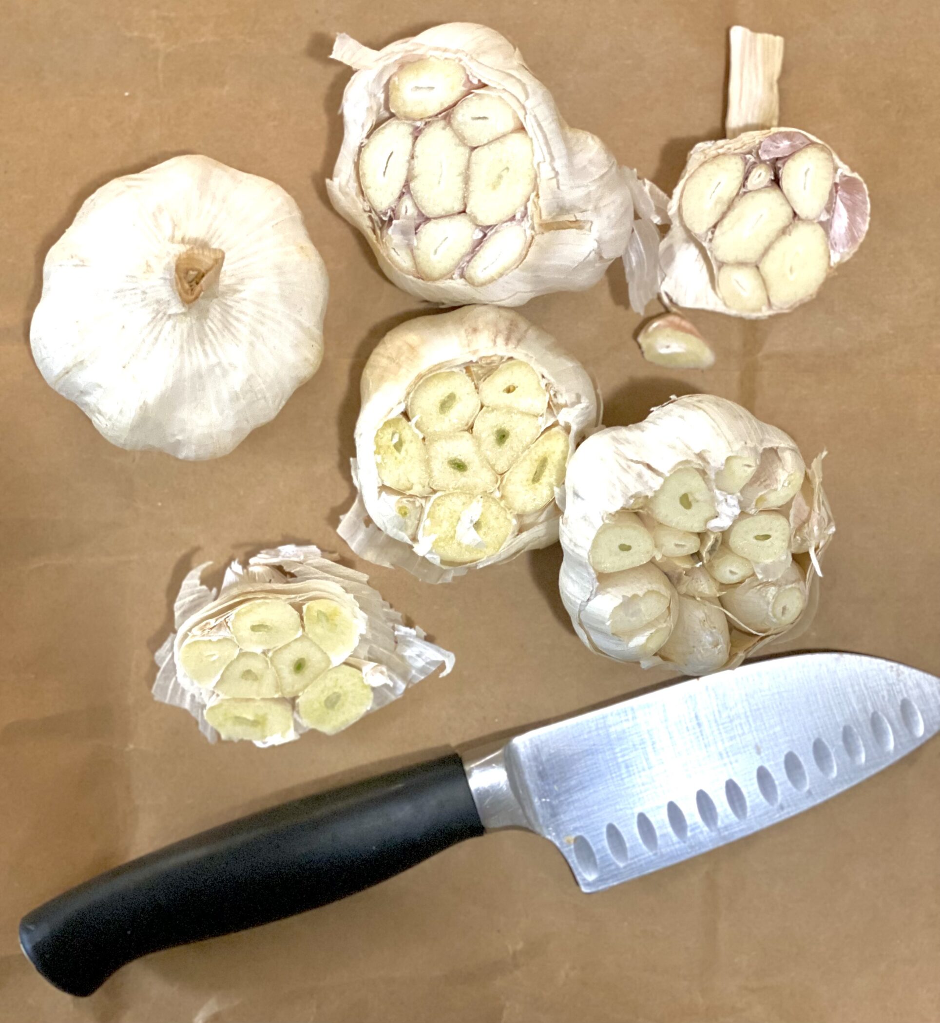 cutting tops off heads of garlic