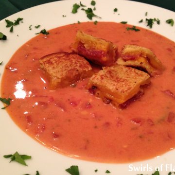 The classic Creamy Tomato Soup With Cheddar Bacon Grilled Cheese Croutons   simmers on your stove top and will warm you up on a chilly fall day topped with grilled cheese croutons of crispy bacon, sharp cheddar cheese and potato bread.