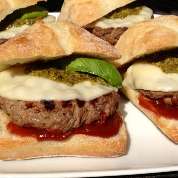 Seasoned with a zesty Italian flavorings and sundried tomatoes and topped with provolone, pesto and a Balsamic ketchup these burgers are packed with flavor! burgers | grilling | pesto | cheese | Italian | provolone | Memorial Day | barbecue