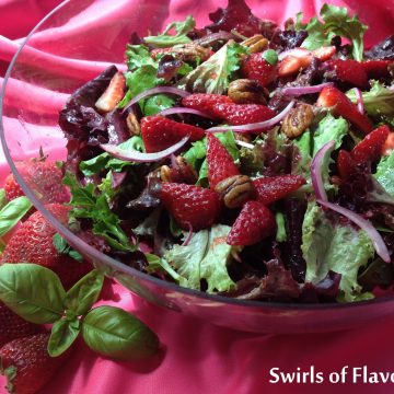 Strawberry Baby Greens Salad with Buttery Spiced Pecans has a hint of spice with a strawberry basil balsamic vinaigrette coating the delicate salad greens. strawberry | spring fruit | salad | balsamic vinaigrette | basil | #swirlsofflavor