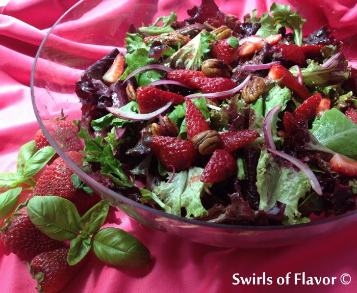 Strawberry Baby Greens Salad with Buttery Spiced Pecans has a hint of spice with a strawberry basil balsamic vinaigrette coating the delicate salad greens. strawberry | spring fruit | salad | balsamic vinaigrette | basil | #swirlsofflavor
