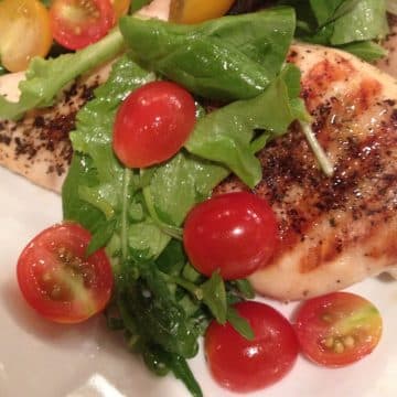 one piece of chicken milanese topped with tossed salad