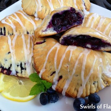 Glazed Blueberry Hand Pies are filled with fresh blueberries tossed with blueberry preserves, cinnamon and lemon and baked to perfection in a buttermilk biscuit dough and drizzled with a confectioners sugar glaze!