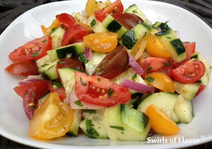 Heirloom Tomato & Cucumber Summer Salad is an easy summer side dish bursting with tomatoes and cucumbers lightly coated in a tangy red wine vinaigrette. Farmers market | vegetables | summer recipe | side dish | vinaigrette | easy recipe | #swirlsofflavor