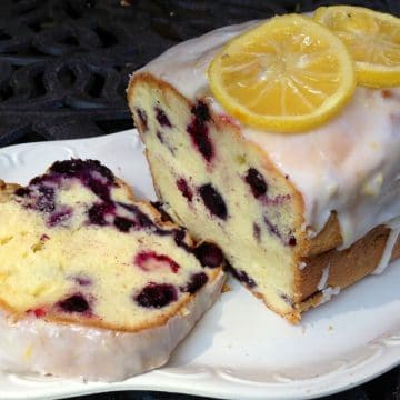 blueberry pound cake with slice on white platter