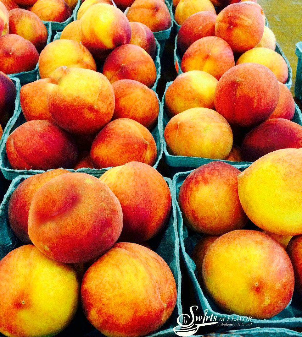 peaches in paper cartons at farmers market