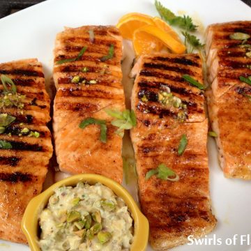Chipotle Honey Glazed Salmon With Pistachio Butter is an easy recipe for the super fish salmon. Salmon fillets are seasoned with just the right amount of spice then glazed over with honey, a touch of orange and topped with pistachio butter that melts down over the fillets after grilling.