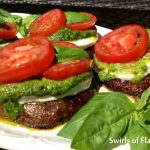 Balsamic Portobellos Caprese in a balsamic marinade are grilled then topped with fresh mozzarella, pesto, compari tomato slices and fresh basil leaves. An easy grilling recipe that's perfect for Meatless Monday in the summer!