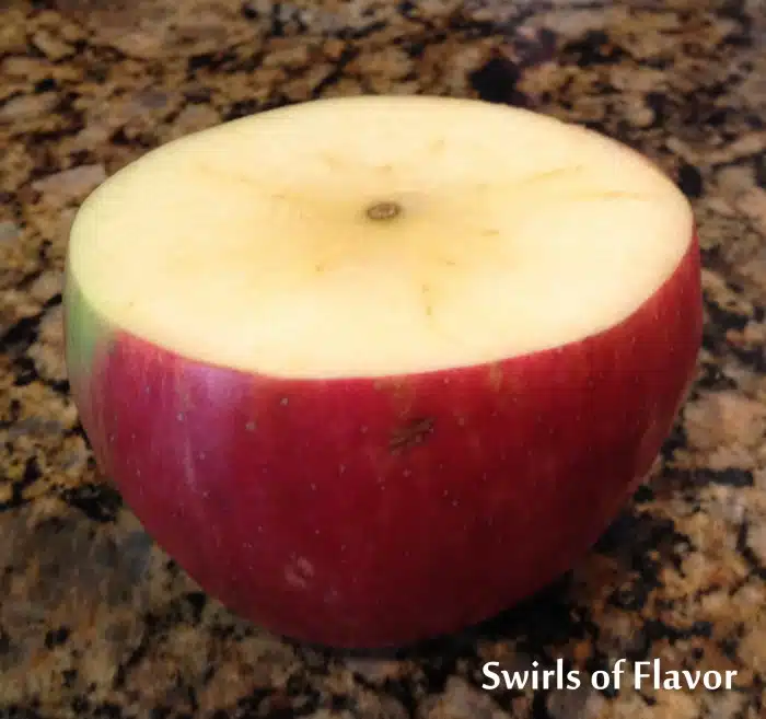 slicing an apple in hald crosswise for baked apples