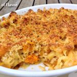 butternut squash mac and cheese in casserole dish with scoop out