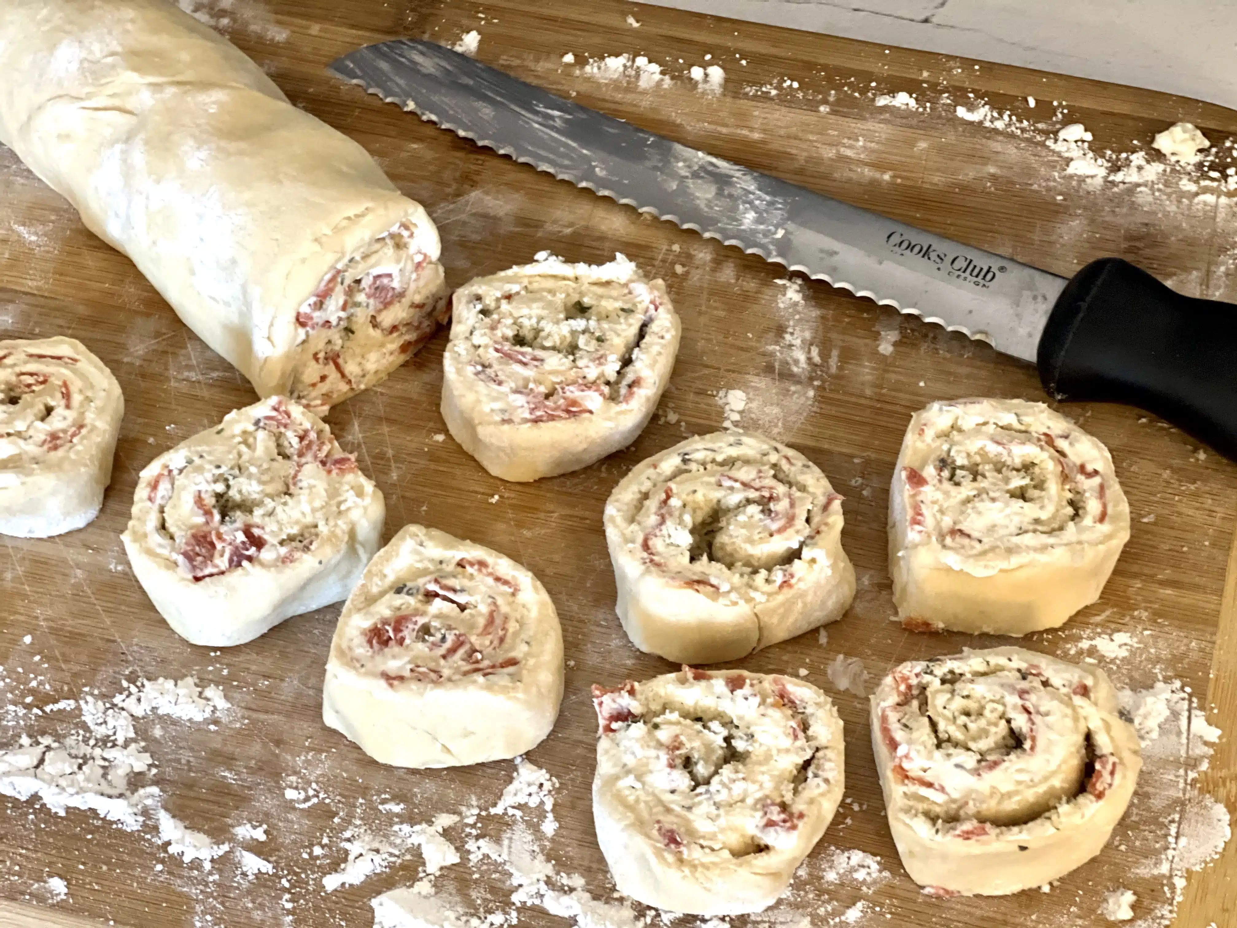 cutting dough into pinwheels with a serrated knife