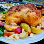 roasted chicken with apples and onions on a white platter
