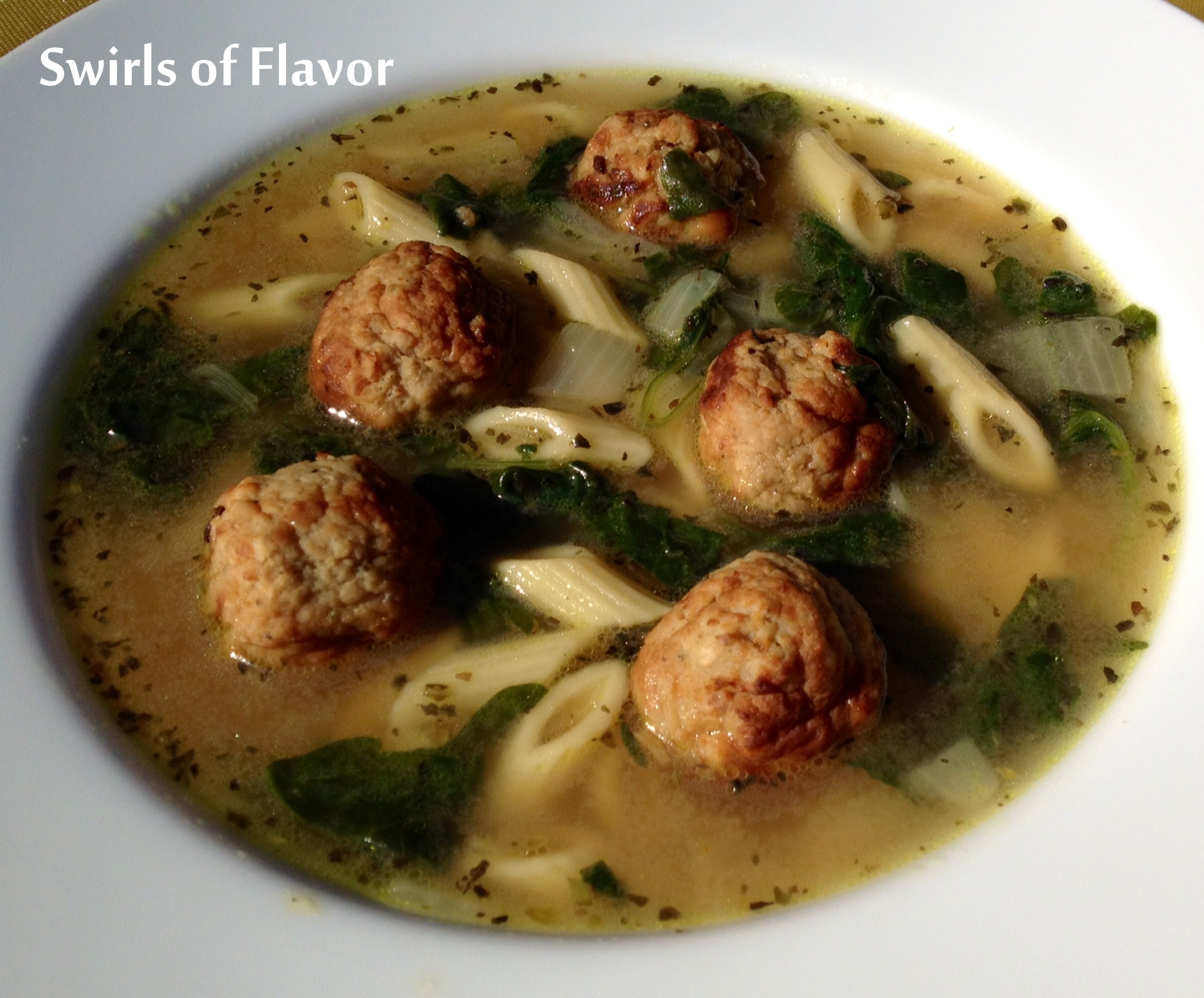 soup with meatballs, pasta and spinach
