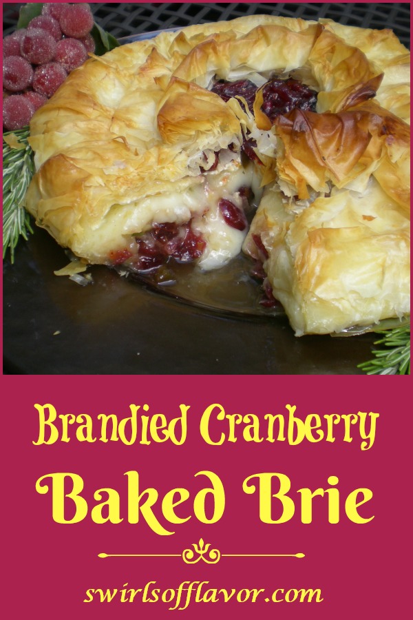 Phyllo Wrapped Brandied Cranberry Baked Brie is an easy recipe of phyllo dough layers surrounding a cranberry brandy topped Brie accented with a hint of rosemary and Dijon and a touch of spice. This holiday appetizer recipe will impress your guests for sure! #bakedbrie #brandy #cranberry #phyllodough #appetizer #holiday #Thanksgiving #swirlsofflavor