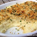 Panko Garlic Mashed Potatoes are infused with fresh garlic, topped with a buttery panko crumb and baked into a golden crusted creamy casserole. A perfect potato recipe for the holidays and entertaining. #potatorecipe #mashedpotatoes #garlicpotatoes #sidedish #easyrecipe #holidayrecipe #entertaining #easymashedpotatoes #swirlsofflavor