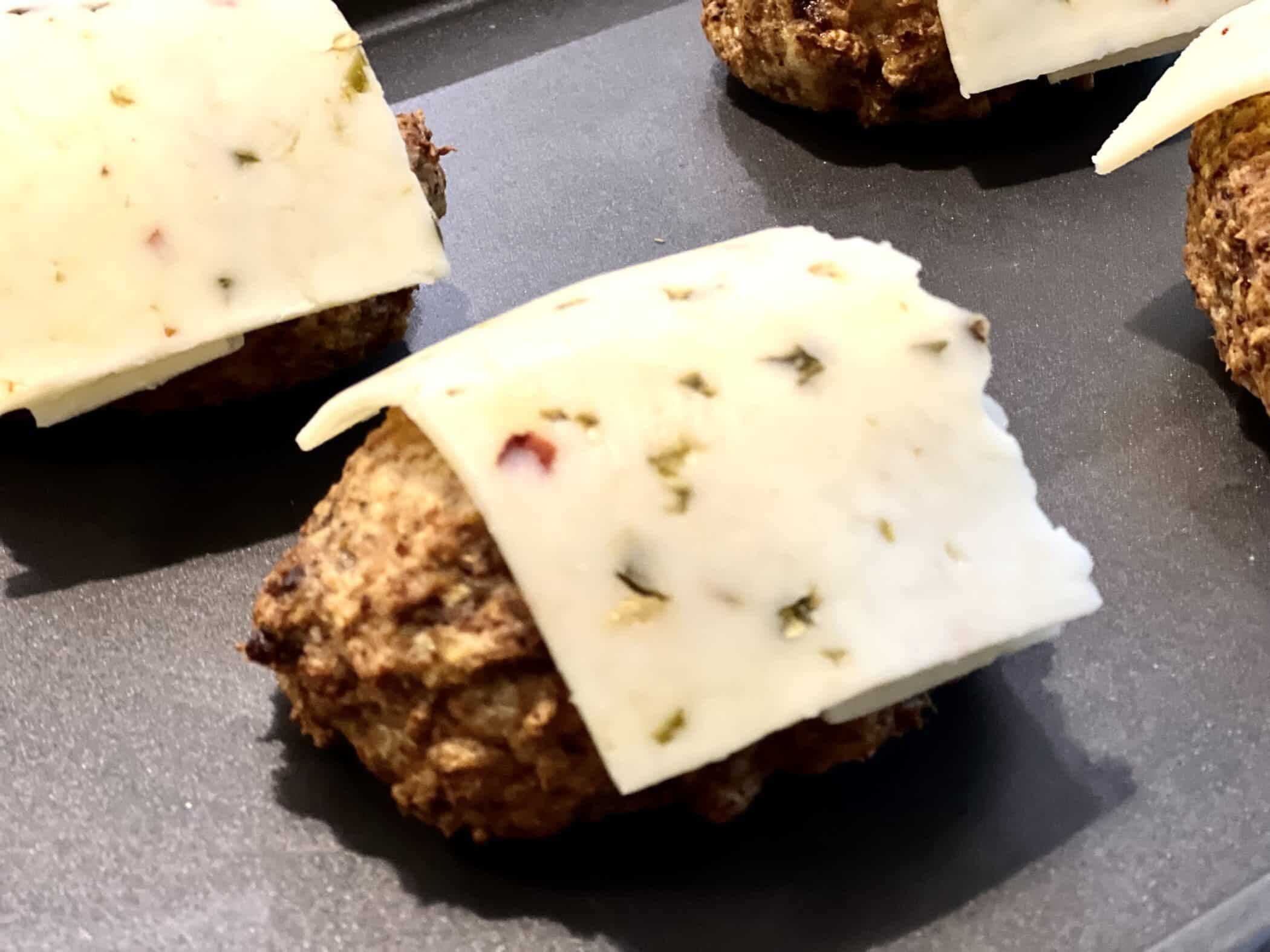cheese on top of mini meatloaf