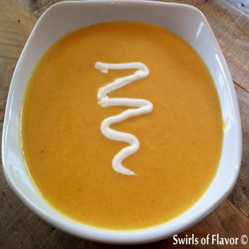 bowl of roasted butternut squash soup with sour cream swirl