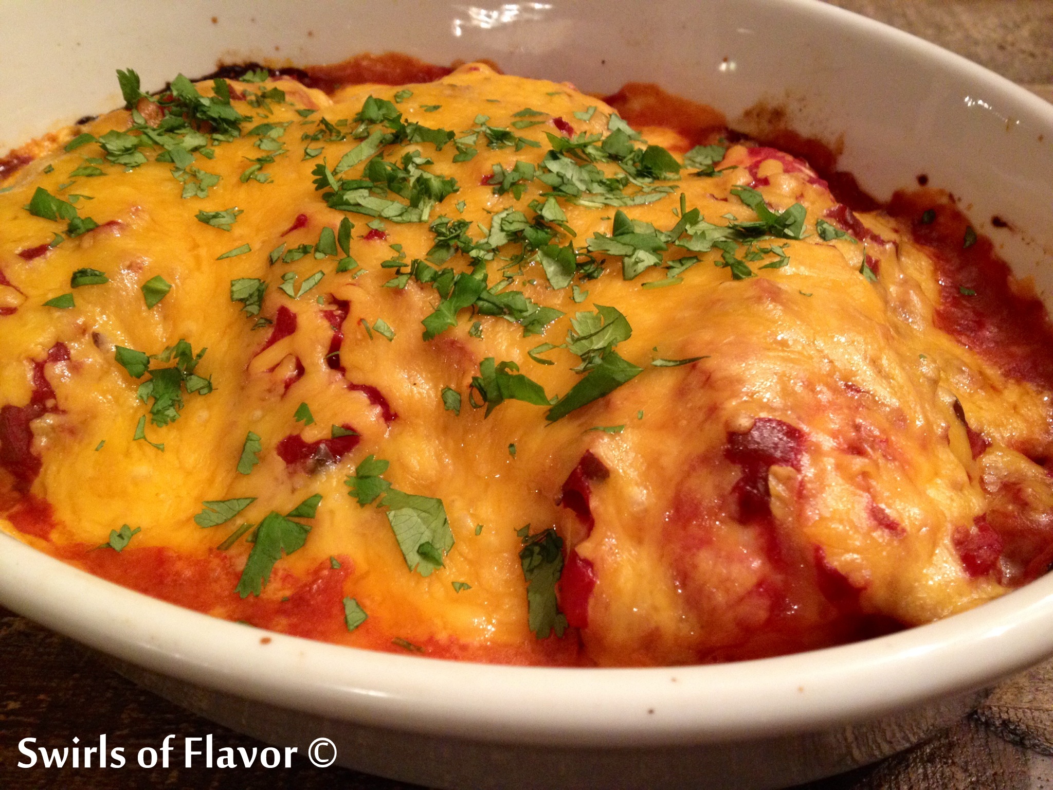 baked mexican chicken casserole with salsa and cheese in a baking dish