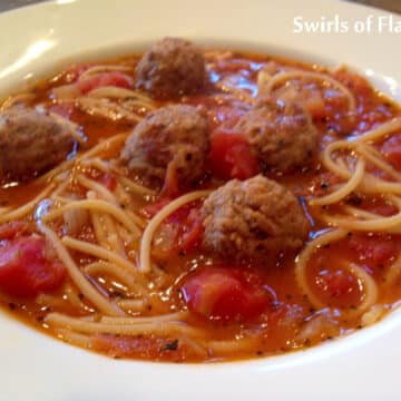 bowl of spaghetti soup with meatballs