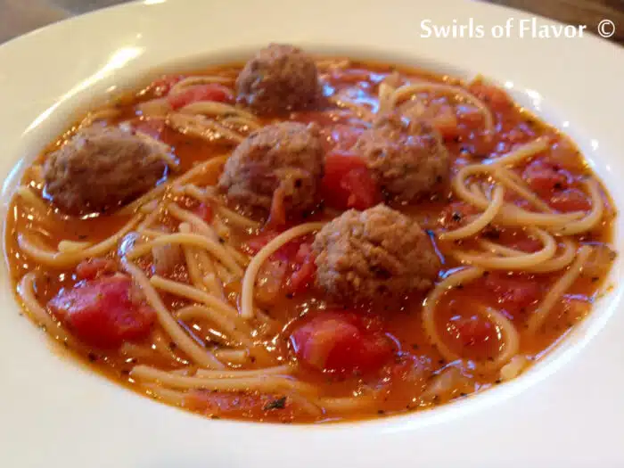 bowl of spaghetti soup with meatballs