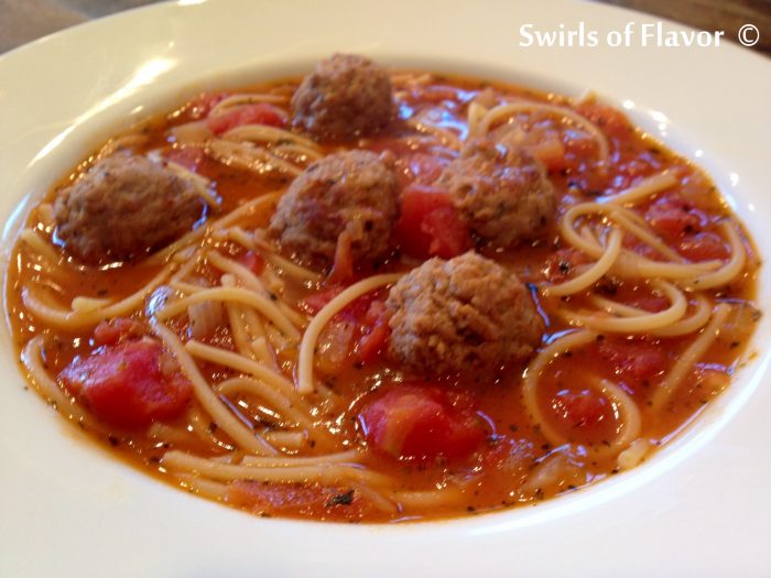 Spaghetti and Meatball Soup is a fun twist on the all-time favorite comfort food. All the elements of a traditional spaghetti and meatball dinner, spaghetti, meatballs and tomatoes, are combined in a bowl of soup! An easy recipe that's on the table in less than 30 minutes and so much fun for kids too! #spaghetti #meatballs #spaghettiandmeatballs #soup #homemade #funforkids #easyrecipe #lessthan30minutes #swirlsofflavor