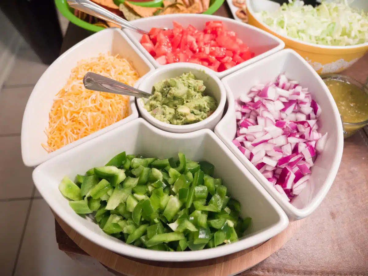 nacho toppings in a white serving dish