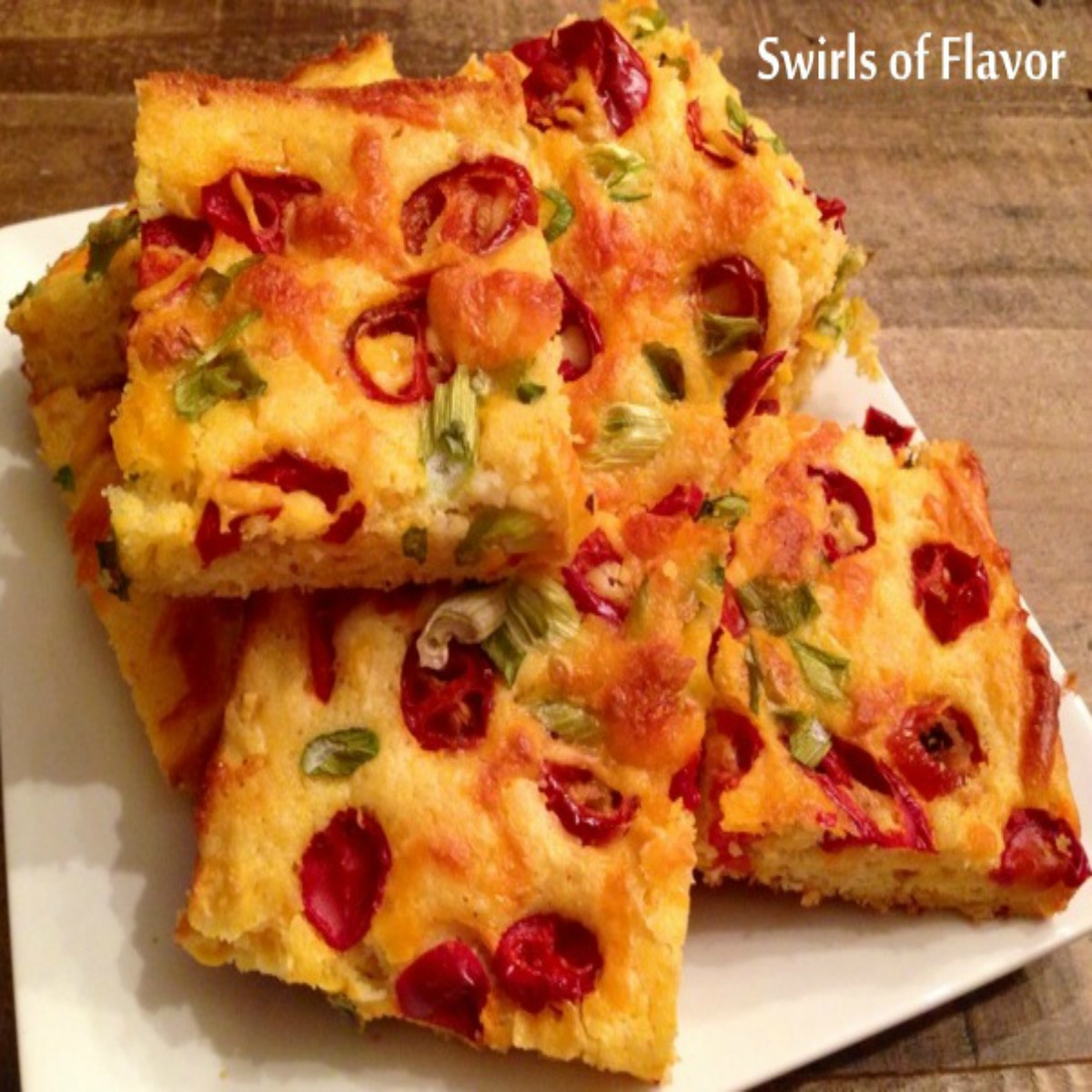 Jalapeno Cheddar cornbread cut in squares and on a platter