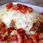 meatloaf topped with cheese and tomatoes