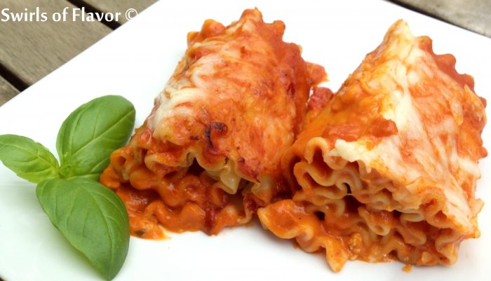 Take the ordinary out of dinner tonight with Lasagna Roll-Ups all Vodka, an easy recipe that you can make ahead! Top lasagna noodles with cheese, roll up and bake with vodka sauce! Perfect for your Meatless Monday, your Sunday Supper, your weeknight dinner and fancy enough for entertaining! #lasagna #vodkasauce #lasagnarollups #makeahead #pasta #easyrecipe #meatlessMonday #entertaining #dinner #swirlsofflavor