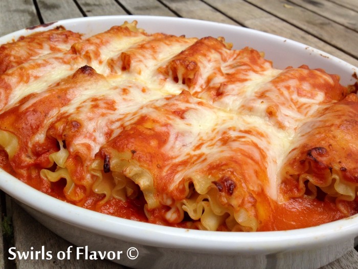 Take the ordinary out of dinner tonight with Lasagna Roll-Ups all Vodka, an easy recipe that you can make ahead! Top lasagna noodles with cheese, roll up and bake with vodka sauce! Perfect for your Meatless Monday, your Sunday Supper, your weeknight dinner and fancy enough for entertaining! #lasagna #vodkasauce #lasagnarollups #makeahead #pasta #easyrecipe #meatlessMonday #entertaining #dinner #swirlsofflavor