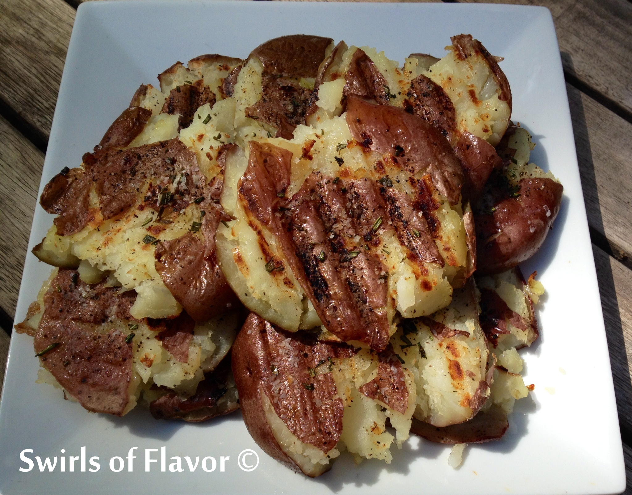 Grilled Smashed Rosemary Potatoes are an easy side dish recipe that cook on the grill and are perfectly seasoned with fresh rosemary and garlic powder! easy recipe | Father's Day | grilling | potatoes | fresh herbs | rosemary | #swirlsofflavor