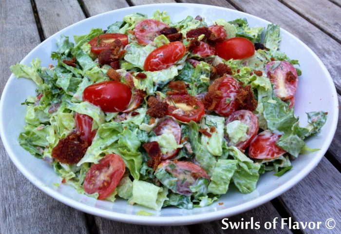 Lettuce tossed in creamy dressing with bacon and tomato