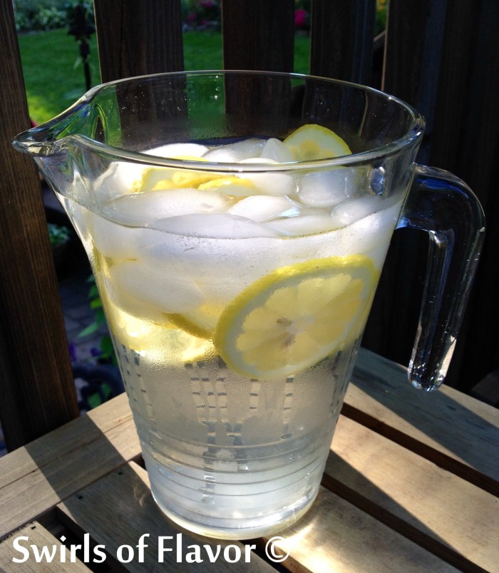The Benefits of Drinking Water are many! Add lemon and the benefits increase. Check out how much water you should be drinking and the increased benefits of adding lemon! #lemon #water #benefitsofwater #benefitsoflemonwater #keephydrated #swirlsofflavor