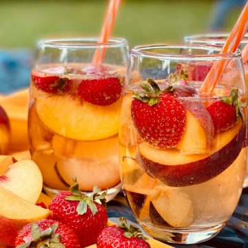 glasses of sangria with fresh fruit and straws