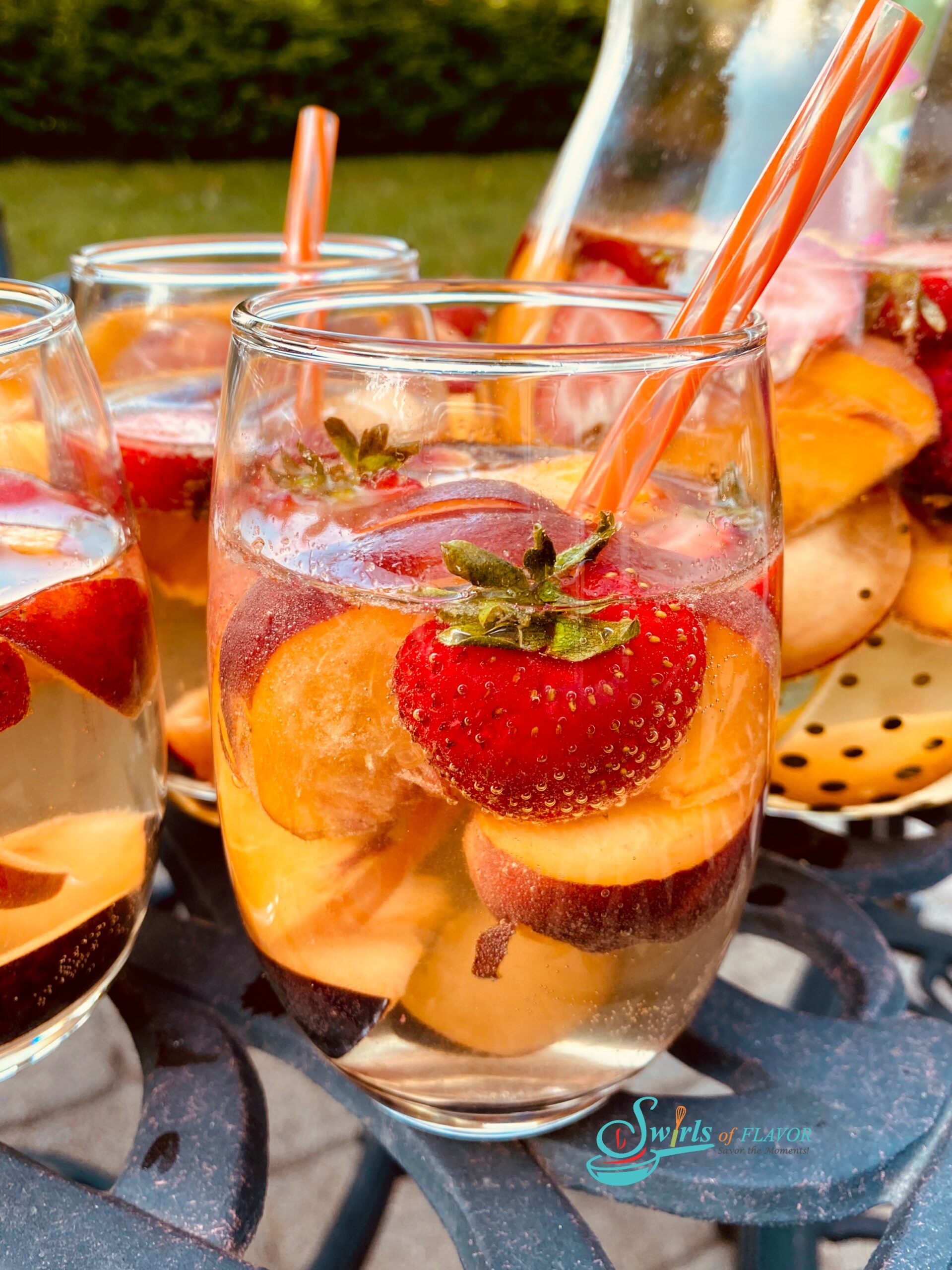 stemless wine glasses filled with peach sangria and fresh fruit