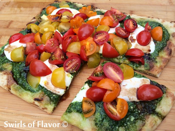 Grilled pizza crust topped with Kale Pesto , fresh mozzarella, gorgeous juicy heirloom tomatoes and drizzled with balsamic vinegar will delight your taste buds and make you wish summer will never end! 