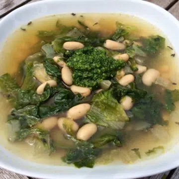 escarole soup with white beans in white bowl