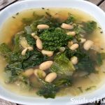 White Bean and Escarole Soup is a hearty vegetarian soup that's bursting with the flavors of fresh escarole, pesto and white beans. White Bean and Escarole Soup is a versatile recipe that can be either vegetarian, when prepared as is, or can be turned into a hearty chicken soup when replacing vegetable broth with chicken broth and adding shredded rotisserie chicken! #homemade #homemadesoup #fromscratchrecipe #easyrecipe #meatlessMonday #vegetarian #escarole #whitebeans #swirlsofflavor