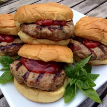 turkey burgers on buns with fresh basil