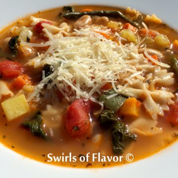 minestrone soup recipe in bowl with shredded Paremsan cheese