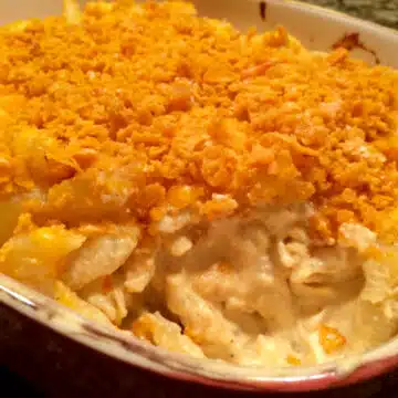 macaroni and cheese casserole with a scoop out