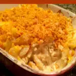 baking dish with baked mac and cheese and scoop out with text overlay