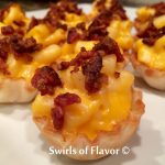 Bacon Mac N Cheese Bites is an easy recipe for a last minute holiday appetizer. With just three ingredients you can have this bite of cheesy goodness in just minutes! Bacon with macaroni and cheese is a perfect last minute holiday recipe that everyone will love! #appetizer #easyrecipe #macaroniandcheese #bacon #threeingredients #holiday #Thanksgiving #Christmas #lastminute #swirlsofflavor