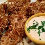 Pretzel Ranch Chicken Tenders is an easy recipe with a crunchy pretzel coating and spicy dipping sauce making them a perfect appetizer for movie night or watching the big game. Serve them with a Buffalo Ranch Dipping Sauce and this baked pretzel-crusted chicken tenders recipe will be a favorite in no time! #chickentenders #bakedchicken #funforkids #easyrecipe #buffalodippingsauce #ranchdippingsauce #bakedchickentenders #pretzelcoatedchicken #pretzelcrust #swirlsofflavor #healthychickenrecipe