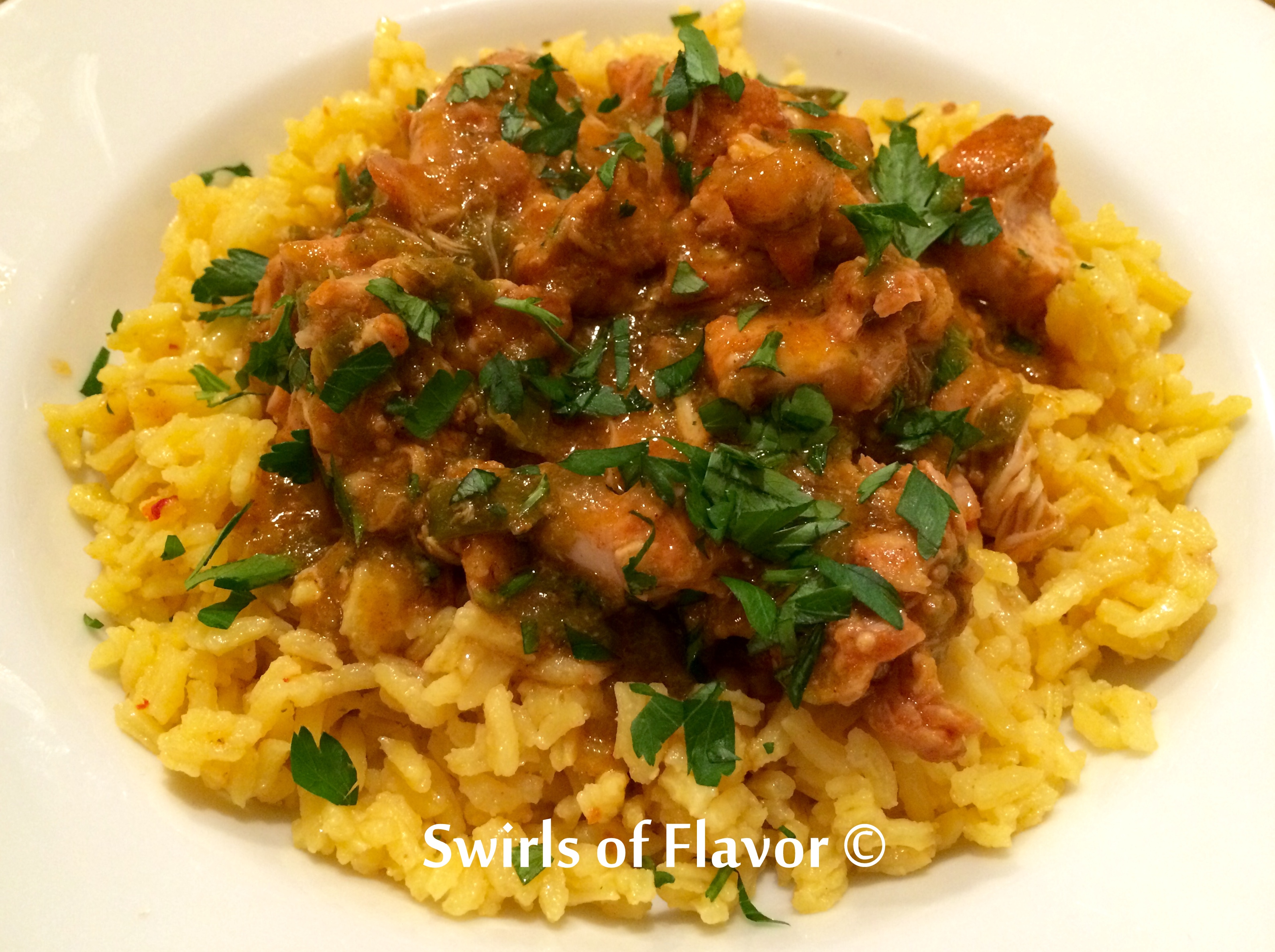 Salsa Verde Chicken over yellow rice with chopped cilantro