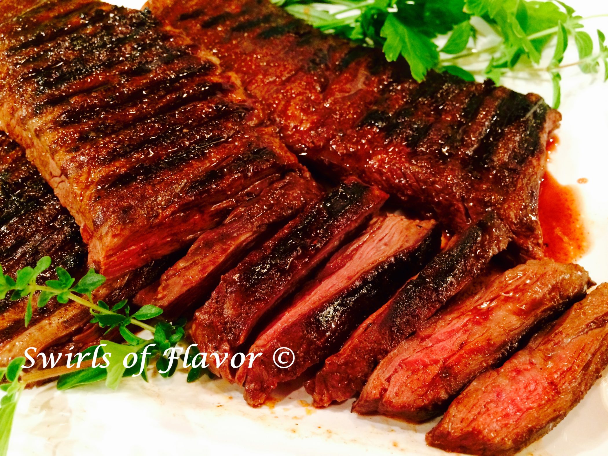 Skirt steak recipe with slices and fresh herbs