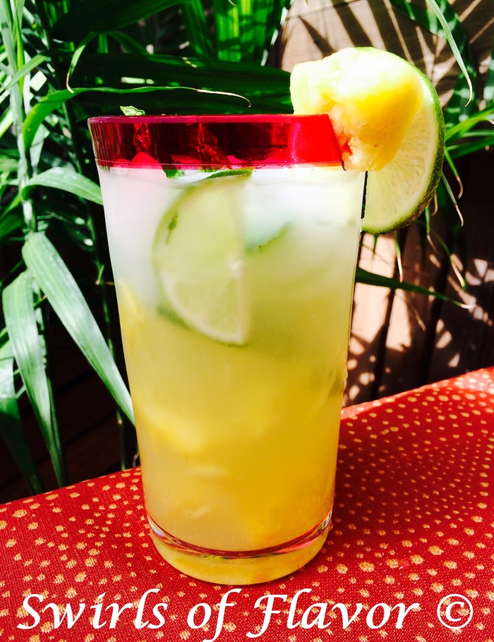 Pineapple Mojito Punch is an easy recipe that takes the traditional Mojito to a tropical paradise with the addition of bits of fresh pineapple and pineapple rum for a refreshing summer drink! #rum #pineapplerum #mojitorecipe #easydrinkrecipe #happyhour #cocktail #summerrecipe #swirlsofflavor