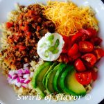 Brown Rice Taco Bowl is filled with seasoned beef and salsa, creamy avocado, juicy tomatoes, cheddar cheese and red onion over good-for-you brown rice. All the flavors of a taco in a bowl! #tacos #tacotuesday #brownrice #tacobowl #avocado #dinner #easyrecipe #notortillataco #swirlsofflavor