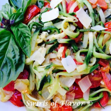 close up of zucchini noodles recipe with tomatoes and fresh basil